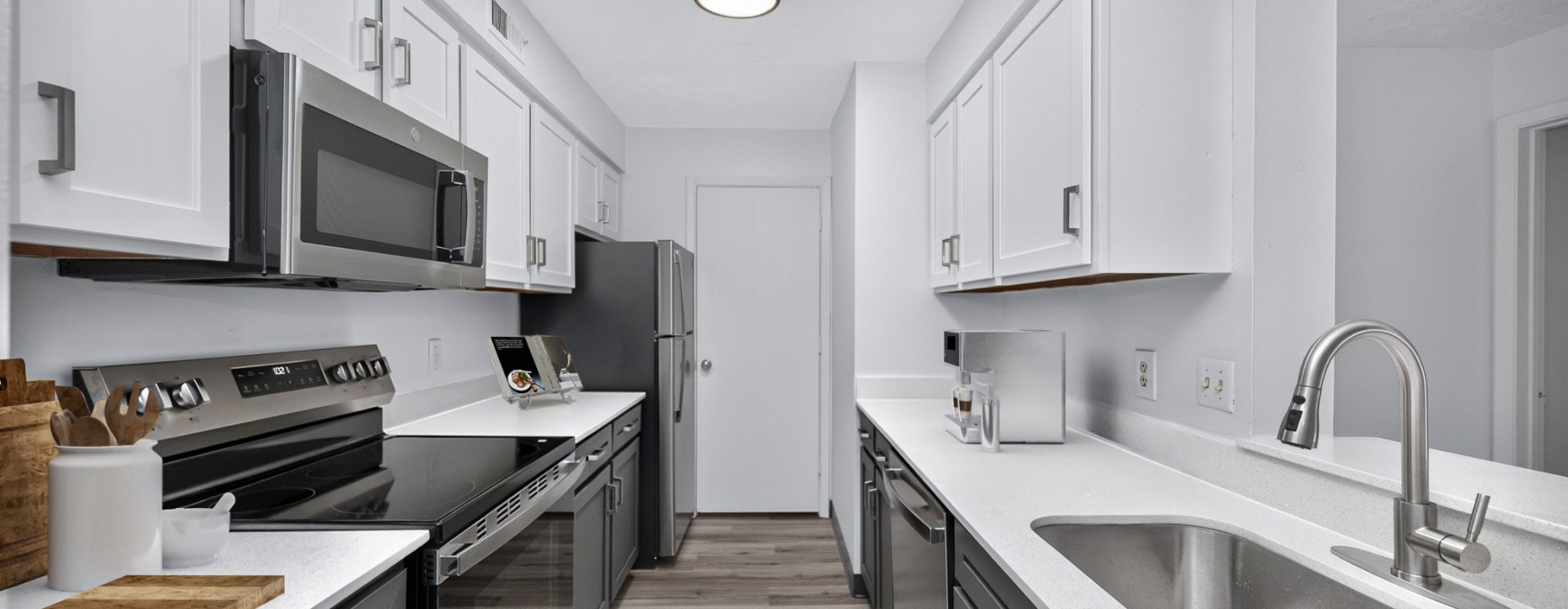 Staged apartment kitchen with white cabinets