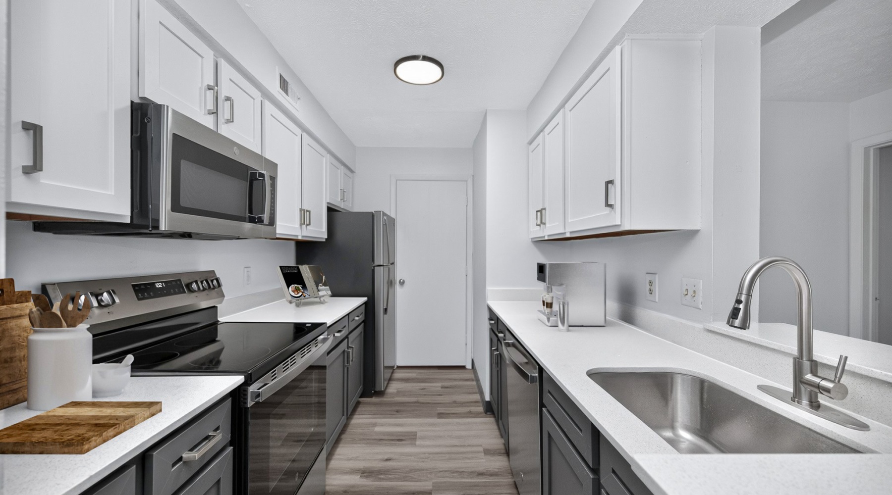 Staged apartment kitchen with white cabinets