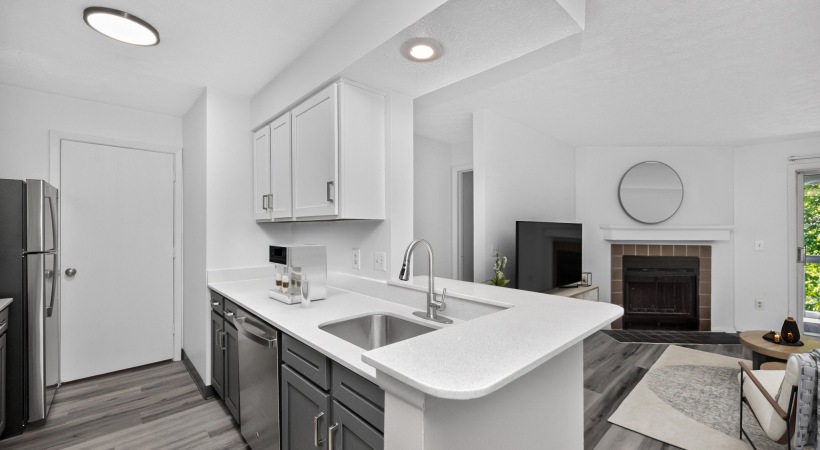 Staged upgraded apartment kitchen with white walls