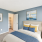 Staged bedroom with sailboat wall art