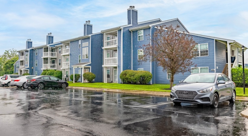 Your Luxury Home Awaits You Blue and white siding of an apartment building