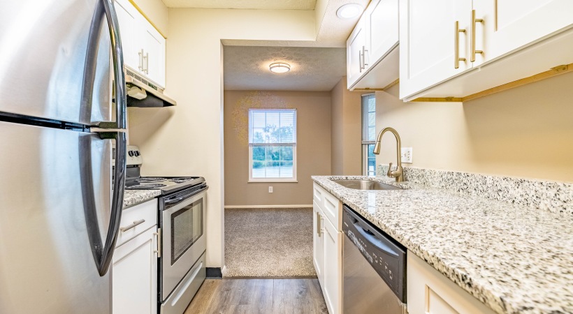 Apartments with brown cabinets and granite countertops upgraded apartment kitchen