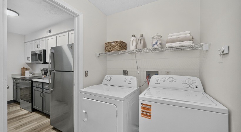 Staged upgraded apartment kitchen with white walls
